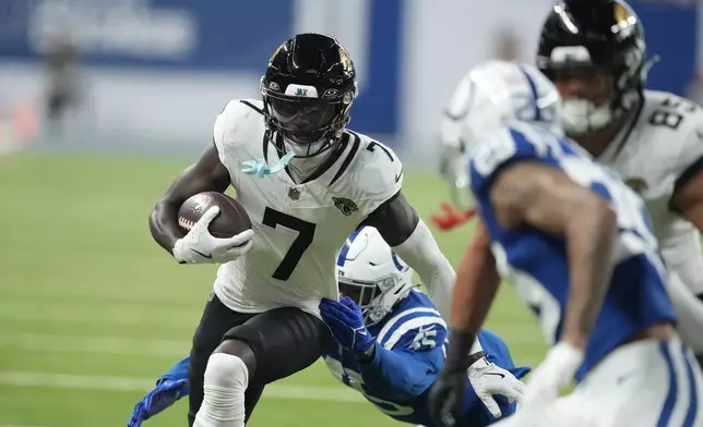 Jacksonville Jaguars wide receiver Brian Thomas Jr. (7) runs with the ball past Indianapolis Colts linebacker E.J. Speed (45) during the first half of an NFL football game, Sunday, Jan. 5, 2025, in Indianapolis. (AP Photo/Darron Cummings)