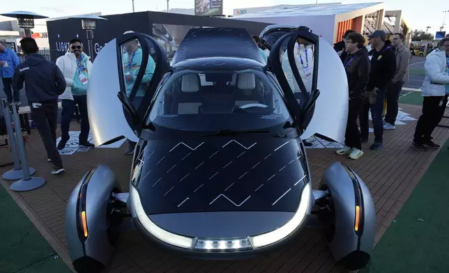 People look at a prototype solar electric vehicle by Aptera Motors during the CES tech show Tuesday, Jan. 7, 2025, in Las Vegas. (AP Photo/John Locher)