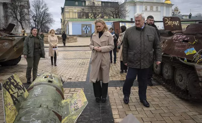 Iceland's Foreign Minister Thorgerdur Katrin Gunnarsdottir, left, and Ukraine's Foreign Minister Andriiy Sybiha look at fragments of Russian rocket in central Kyiv, Ukraine, Tuesday, Jan. 7, 2025. (AP Photo/Efrem Lukatsky)