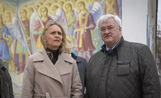 Iceland's Foreign Minister Thorgerdur Katrin Gunnarsdottir, left, and Ukraine's Foreign Minister Andriiy Sybiha stand at the entrance of St. Michael Monastery in Kyiv, Ukraine, Tuesday, Jan. 7, 2025. (AP Photo/Efrem Lukatsky)