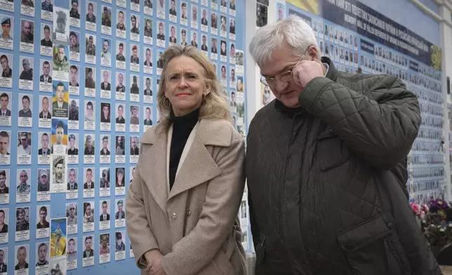 Iceland's Foreign Minister Thorgerdur Katrin Gunnarsdottir, left, and Ukraine's Foreign Minister Andriiy Sybiha attend a flower laying ceremony at the Memory Wall of Fallen Defenders of Ukraine in Kyiv, Ukraine, Tuesday, Jan. 7, 2025. (AP Photo/Efrem Lukatsky)