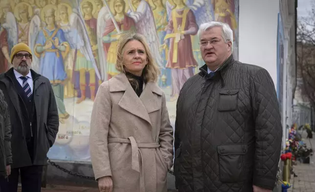 Iceland's Foreign Minister Thorgerdur Katrin Gunnarsdottir, left, and Ukraine's Foreign Minister Andriiy Sybiha at the entrance of St. Michael Monastery in Kyiv, Ukraine, Tuesday, Jan. 7, 2025. (AP Photo/Efrem Lukatsky)