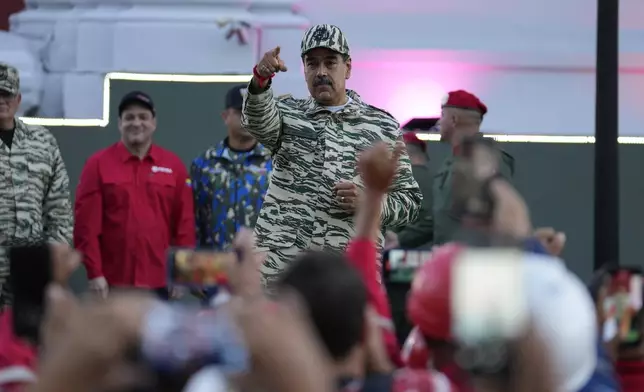 President Nicolas Maduro points the crowd during a march in Caracas, Venezuela, Tuesday, Jan. 7, 2025, days ahead of his inauguration for a third term. (AP Photo/Matias Delacroix)