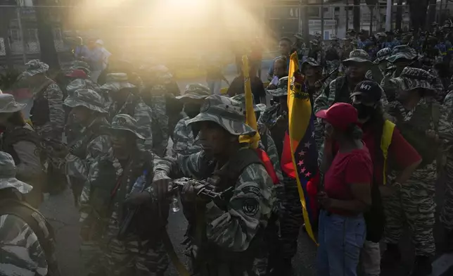 The sun shines onto a pro-government march in Caracas, Tuesday, Jan. 7, 2025, days ahead of President Nicolas Maduro's inauguration for a third term. (AP Photo/Matias Delacroix)