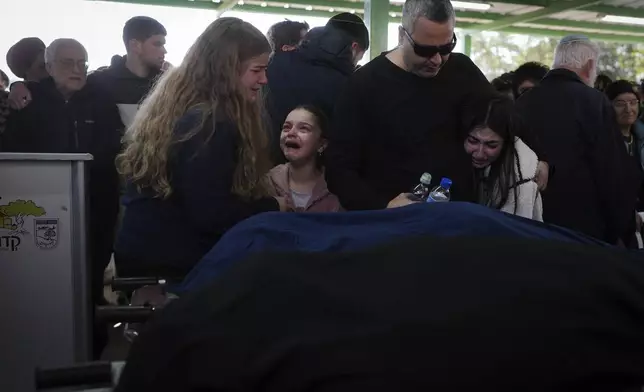 Mourners attend the funeral of Rachel Cohen, 73, and Aliza Raiz, 70, who were killed yesterday in a Palestinian shooting attack in the West Bank, at a cemetery in the West Bank Jewish settlement of Kdumim, Tuesday, Jan. 7, 2025. (AP Photo/Ohad Zwigenberg)