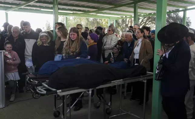 Mourners attend the funeral of Rachel Cohen, 73, and Aliza Raiz, 70, who were killed yesterday in a Palestinian shooting attack in the West Bank, at a cemetery in the West Bank Jewish settlement of Kdumim, Tuesday, Jan. 7, 2025. (AP Photo/Ohad Zwigenberg)