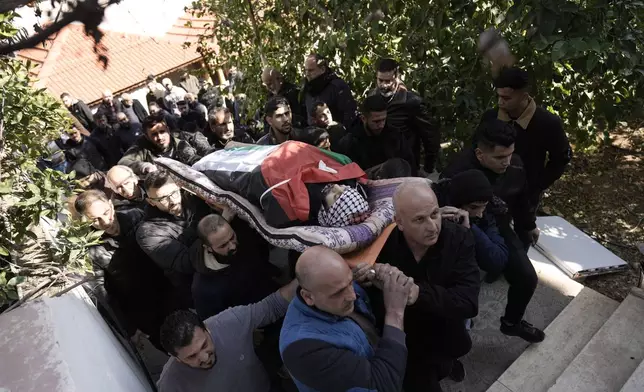 Mourners carry the body of Jaafar Dababsah, a Palestinian Hamas commander killed in a raid by Israeli forces, during his funeral in the village of Talouza, near the West Bank city of Nablus, Tuesday, Jan. 7, 2025. (AP Photo/Majdi Mohammed)