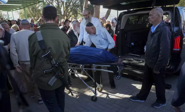 Mourners carry the bodies of Rachel Cohen, 73, and Aliza Raiz, 70, who were killed yesterday in a Palestinian shooting attack in the West Bank, during their funeral at a cemetery in the West Bank Jewish settlement of Kdumim, Tuesday, Jan. 7, 2025. (AP Photo/Ohad Zwigenberg)