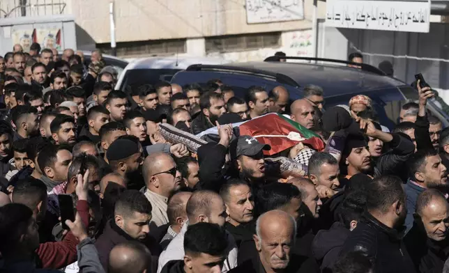 Mourners carry the body of Jaafar Dababsah, a Palestinian Hamas commander killed in a raid by Israeli forces, during his funeral in the village of Talouza, near the West Bank city of Nablus, Tuesday, Jan. 7, 2025. (AP Photo/Majdi Mohammed)