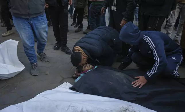 Mourners attend the funeral of three members of Hussein family who were killed in the Israeli bombardment in Maghazij, central Gaza Strip, at Al-Aqsa Martyrs Hospital in Deir al-Balah, Tuesday, Jan. 7, 2025. (AP Photo/Abdel Kareem Hana)