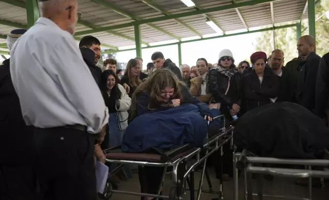 Mourners attend the funeral of Rachel Cohen, 73, and Aliza Raiz, 70, who were killed yesterday in a Palestinian shooting attack in the West Bank, at a cemetery in the West Bank Jewish settlement of Kdumim, Tuesday, Jan. 7, 2025. (AP Photo/Ohad Zwigenberg)