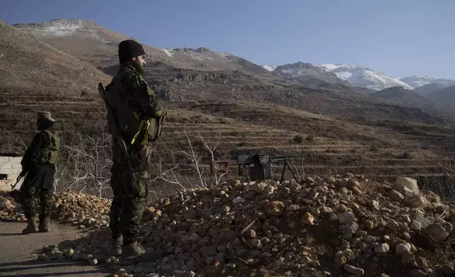 Members of the new security forces stand guard at a checkpoint located near the border with Lebanon, in the town of Serghaya, Syria, Tuesday, Jan. 7, 2025. (AP Photo/Leo Correa)