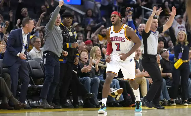 FILE - Golden State Warriors guard Buddy Hield (7) reacts after making a 3-point basket against the Minnesota Timberwolves during the second half of an NBA basketball game in San Francisco, Dec. 8, 2024. (AP Photo/Tony Avelar, File)