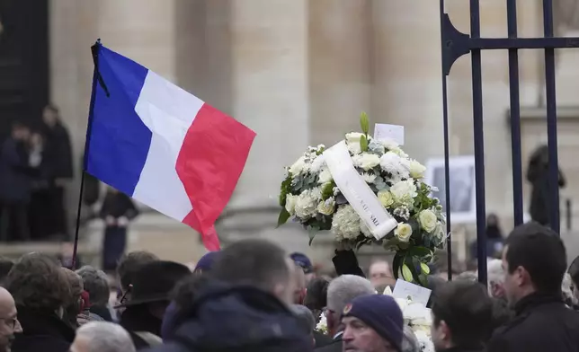 People wait outside Notre Dame du Val-de-Grace church before a public memorial for late far-right leader Jean-Marie Le Pen, Thursday, Jan. 16, 2025 in Paris. Jean-Marie Le Pen, the founder of France's main far-right party, died on Jan.7, 2025 aged 96. (AP Photo/Thibault Camus)