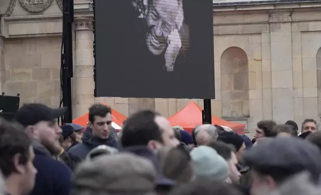 People wait outside Notre Dame du Val-de-Grace church before a public memorial for late far-right leader Jean-Marie Le Pen, Thursday, Jan. 16, 2025 in Paris. Jean-Marie Le Pen, the founder of France's main far-right party, died on Jan.7, 2025 aged 96. (AP Photo/Michel Euler)