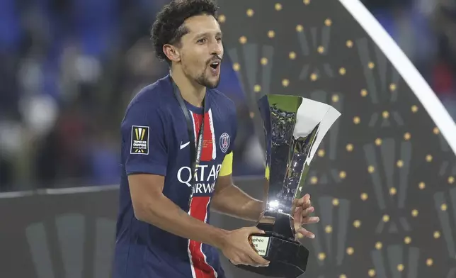 PSG's Marquinhos holds the trophy after the French Super Cup final match between Paris Saint Germain and Monaco in Doha, Qatar, on Sunday, Jan. 5, 2025.(AP Photo/Hussein Sayed)