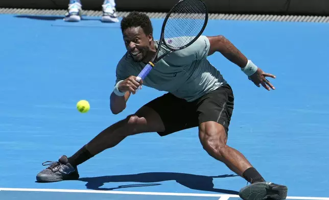 Gael Monfils of France plays a forehand return to Giovanni Mpetshi Perricard of France during their first round match at the Australian Open tennis championship in Melbourne, Australia, Tuesday, Jan. 14, 2025. (AP Photo/Asanka Brendon Ratnayake)