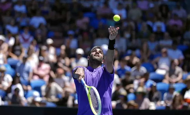 Matteo Berrettini of Italy serves to Cameron Norrie of Britain during their first round match at the Australian Open tennis championship in Melbourne, Australia, Tuesday, Jan. 14, 2025. (AP Photo/Asanka Brendon Ratnayake)