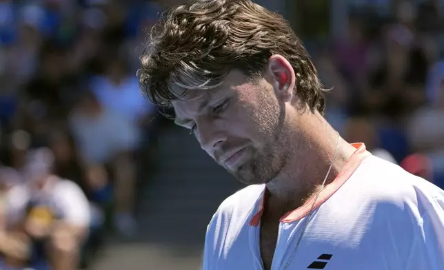 Cameron Norrie of Britain reacts during his first round loss to Matteo Berrettini of Italy at the Australian Open tennis championship in Melbourne, Australia, Tuesday, Jan. 14, 2025. (AP Photo/Asanka Brendon Ratnayake)