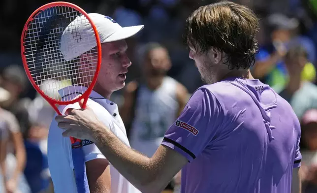Taylor Fritz, right, of the U.S. is congratulated by compatriot Jenson Brooksby following their first round match at the Australian Open tennis championship in Melbourne, Australia, Tuesday, Jan. 14, 2025. (AP Photo/Vincent Thian)