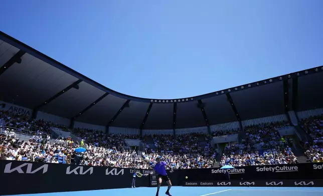 Matteo Berrettini of Italy plays a forehand return to Cameron Norrie of Britain during their first round match at the Australian Open tennis championship in Melbourne, Australia, Tuesday, Jan. 14, 2025. (AP Photo/Asanka Brendon Ratnayake)