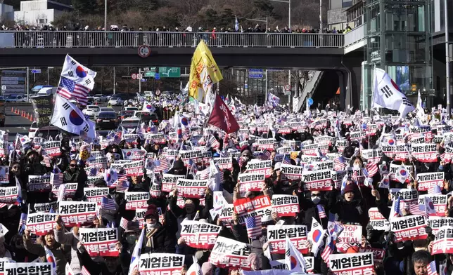 Supporters of impeached South Korean President Yoon Suk Yeol stage a rally to oppose a court having issued a warrant to detain Yoon, near the presidential residence in Seoul, South Korea, Thursday, Jan. 2, 2025. The signs read, "Oppose impeachment." (AP Photo/Ahn Young-joon)