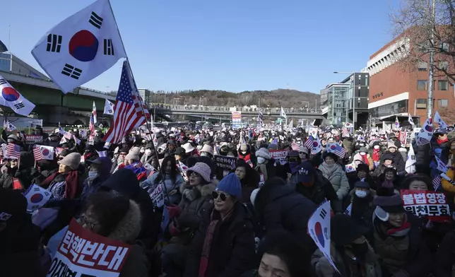 Supporters of impeached South Korean President Yoon Suk Yeol stage a rally to oppose a court having issued a warrant to detain Yoon, near the presidential residence in Seoul, South Korea, Friday, Jan. 3, 2025. The letters read, "Oppose Impeachment." (AP Photo/Lee Jin-man)