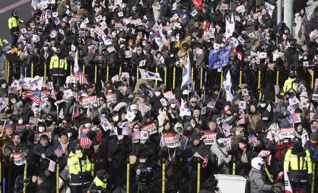 Supporters of impeached South Korean President Yoon Suk Yeol stage a rally to oppose a court having issued a warrant to detain Yoon, near the presidential residence in Seoul, South Korea, Friday, Jan. 3, 2025. The letters read, "Oppose Impeachment." (AP Photo/Lee Jin-man)