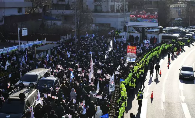 Supporters of impeached South Korean President Yoon Suk Yeol stage a rally to oppose a court having issued a warrant to detain Yoon, as police offices stand guard near the presidential residence in Seoul, South Korea, Friday, Jan. 3, 2025. (AP Photo/Lee Jin-man)