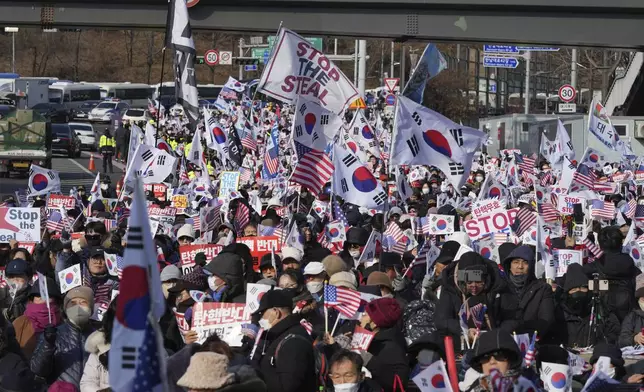 Supporters of impeached South Korean President Yoon Suk Yeol stage a rally to oppose a court having issued a warrant to detain Yoon, near the presidential residence in Seoul, South Korea, Friday, Jan. 3, 2025. The letters read, "Oppose Impeachment." (AP Photo/Lee Jin-man)