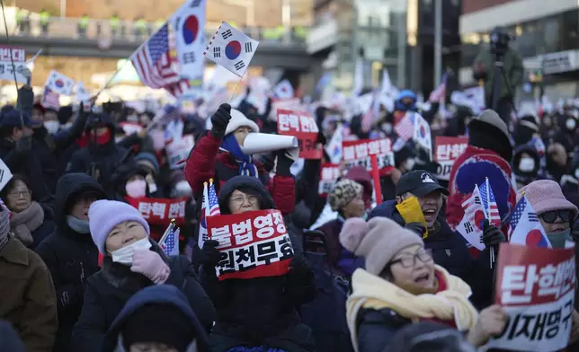 Supporters of impeached South Korean President Yoon Suk Yeol stage a rally to oppose a court having issued a warrant to detain Yoon, near the presidential residence in Seoul, South Korea, Friday, Jan. 3, 2025. The letters read "Oppose Impeachment." (AP Photo/Lee Jin-man)