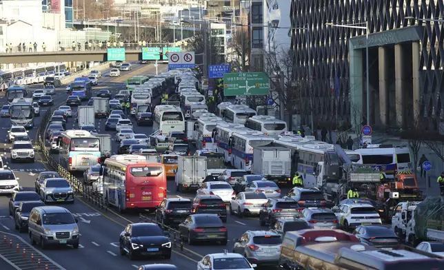 Police vehicles are seen near the gate of the presidential residence in Seoul, South Korea, Friday, Jan. 3, 2025. (AP Photo/Lee Jin-man)