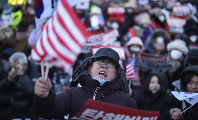 Supporters of impeached South Korean President Yoon Suk Yeol stage a rally to oppose a court having issued a warrant to detain Yoon, near the presidential residence in Seoul, South Korea, Friday, Jan. 3, 2025. The letters read, "Oppose Impeachment." (AP Photo/Lee Jin-man)