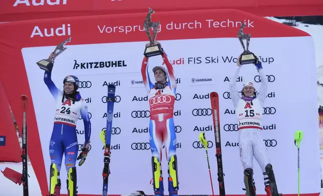 From left, second placed Italy's Alex Vinatzer, the winner France's Clement Noel and third placed Brazil' Lucas Braathen celebrate after an alpine ski, men's World Cup slalom in Kitzbühel, Austria, Sunday, Jan. 26, 2025. (AP Photo/Giovanni Auletta)