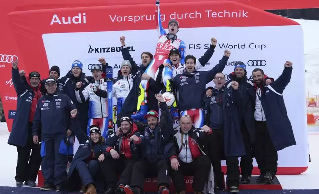 The winner France's Clement Noel celebrates with the team after an alpine ski, men's World Cup slalom in Kitzbühel, Austria, Sunday, Jan. 26, 2025. (AP Photo/Giovanni Auletta)
