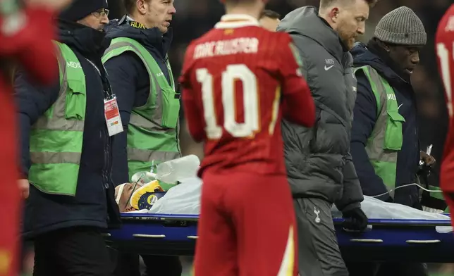 Medics carry Tottenham's Rodrigo Bentancur from the pitch after sustaining an injury during the English League Cup semi final first leg soccer match between Tottenham and Liverpool, at the Tottenham Hotspur Stadium in London, Wednesday, Jan. 8, 2025. (AP Photo/Ian Walton)