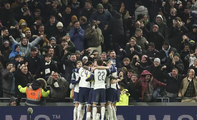 Tottenham's Lucas Bergvall celebrates with teammates after scoring the opening goal during the English League Cup semi final first leg soccer match between Tottenham and Liverpool, at the Tottenham Hotspur Stadium in London, Wednesday, Jan. 8, 2025. (AP Photo/Ian Walton)