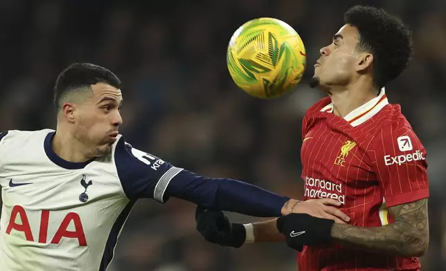 Tottenham's Pedro Porro, left, duels for the ball with Liverpool's Luis Diaz during the English League Cup semi final first leg soccer match between Tottenham and Liverpool, at the Tottenham Hotspur Stadium in London, Wednesday, Jan. 8, 2025. (AP Photo/Ian Walton)