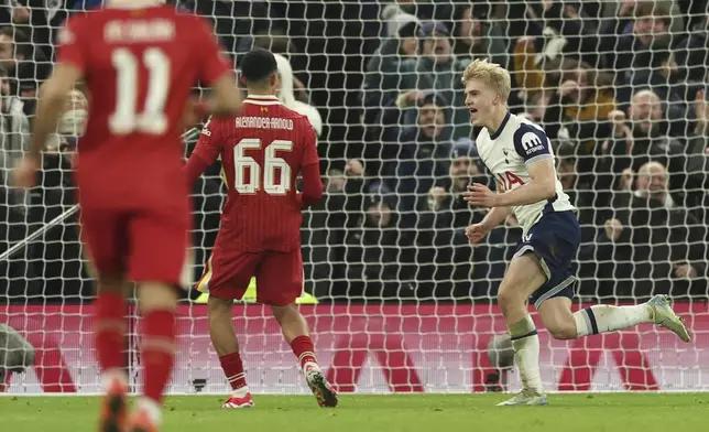 Tottenham's Lucas Bergvall, right, celebrates after scoring the opening goal during the English League Cup semi final first leg soccer match between Tottenham and Liverpool, at the Tottenham Hotspur Stadium in London, Wednesday, Jan. 8, 2025. (AP Photo/Ian Walton)