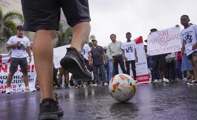 Protesters gather outside the court that is holding a hearing for the soldiers accused of being connected to the disappearance of four children in Guayaquil, Ecuador, Tuesday, Dec. 31, 2024. The children disappeared after playing soccer. (AP Photo/Cesar Munoz)