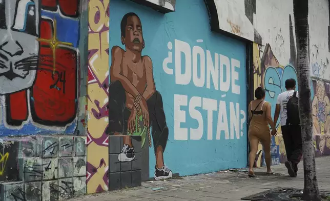 A mural of a child and the Spanish message "Where are they?" cover a wall in protest of the disappearance of four children who were last seen on Dec. 8 running away from a military convoy in Guayaquil, Monday, Dec. 23, 2024. (AP Photo/Cesar Munoz)