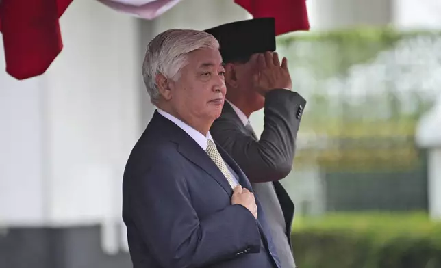 Japan's Defense Minister Gen Nakatani, front, listens to the national anthems with his Indonesian counterpart Sjafrie Sjamsoeddin during a welcoming ceremony prior to their meeting in Jakarta, Indonesia, Tuesday, Jan. 7, 2025. (AP Photo/Achmad Ibrahim)