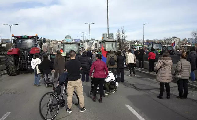 People take part in a student-led 24 hour block on an intersection to protest the deaths of 15 people killed in the November collapse of a train station canopy, in Belgrade, Serbia, Monday, Jan. 27, 2025. (AP Photo/Darko Vojinovic)