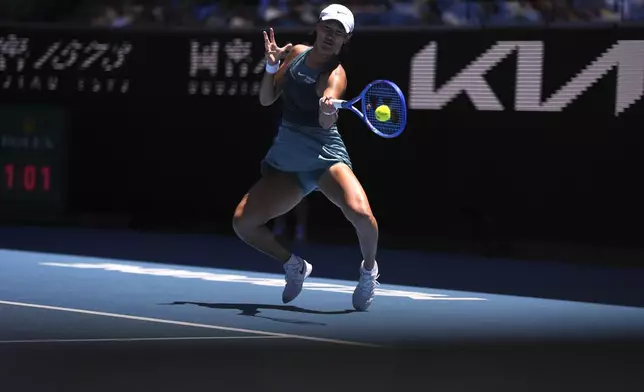 Wang Xiyu of China plays a forehand return to Emma Navarro of the U.S. during their second round match at the Australian Open tennis championship in Melbourne, Australia, Thursday, Jan. 16, 2025. (AP Photo/Ng Han Guan)