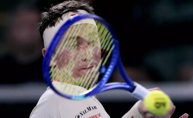Casper Ruud of Norway plays a forehand return to Jakub Mensik of the Czech Republic during their second round match at the Australian Open tennis championship in Melbourne, Australia, Wednesday, Jan. 15, 2025. (AP Photo/Ng Han Guan)