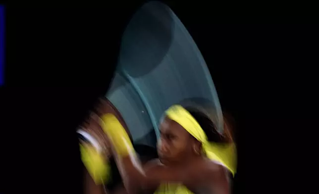 Coco Gauff of the U.S. plays a backhand return to Jodie Burrage of Britain during their second round match at the Australian Open tennis championship in Melbourne, Australia, Wednesday, Jan. 15, 2025. (AP Photo/Vincent Thian)