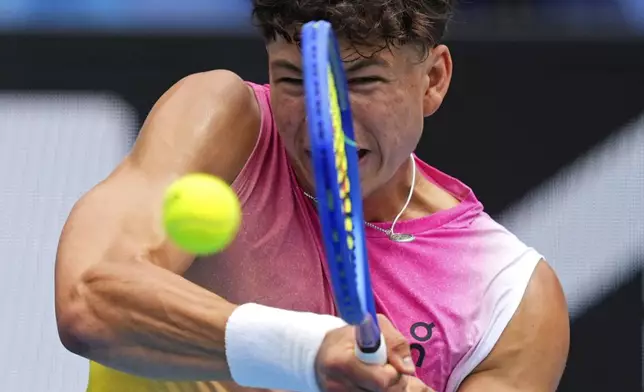 Ben Shelton of the U.S. plays a backhand return to Pablo Carreno Busta of Spain during their second round match at the Australian Open tennis championship in Melbourne, Australia, Thursday, Jan. 16, 2025. (AP Photo/Vincent Thian)