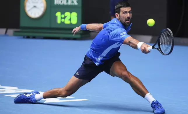 Novak Djokovic of Serbia plays a backhand return to Jaime Faria of Portugal during their second round match at the Australian Open tennis championship in Melbourne, Australia, Wednesday, Jan. 15, 2025. (AP Photo/Vincent Thian)