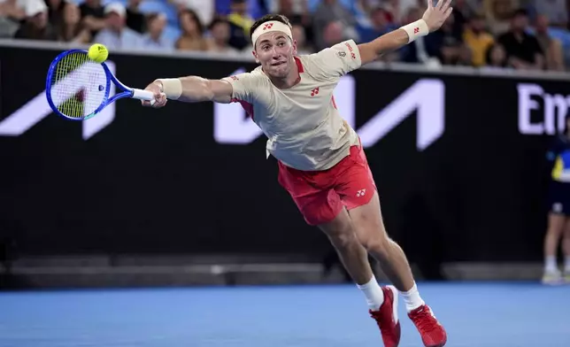 Casper Ruud of Norway plays a forehand return to Jakub Mensik of the Czech Republic during their second round match at the Australian Open tennis championship in Melbourne, Australia, Wednesday, Jan. 15, 2025. (AP Photo/Ng Han Guan)