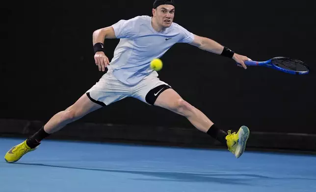 Jack Draper of Britain plays a forehand return to Thanasi Kokkinakis of Australia during their second round match at the Australian Open tennis championship in Melbourne, Australia, Wednesday, Jan. 15, 2025. (AP Photo/Asanka Brendon Ratnayake)
